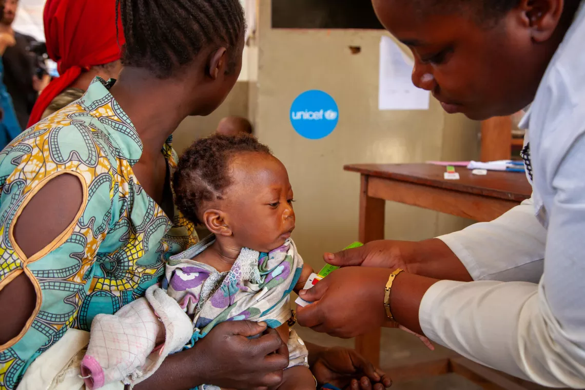  Democratic Republic of the Congo. A baby is screened for malnutrition by a nurse at a UNICEF-supported health centre in South Kivu Province.
