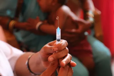 A child getting ready to be vaccinated 