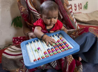 early childhood development_young baby with abacus 