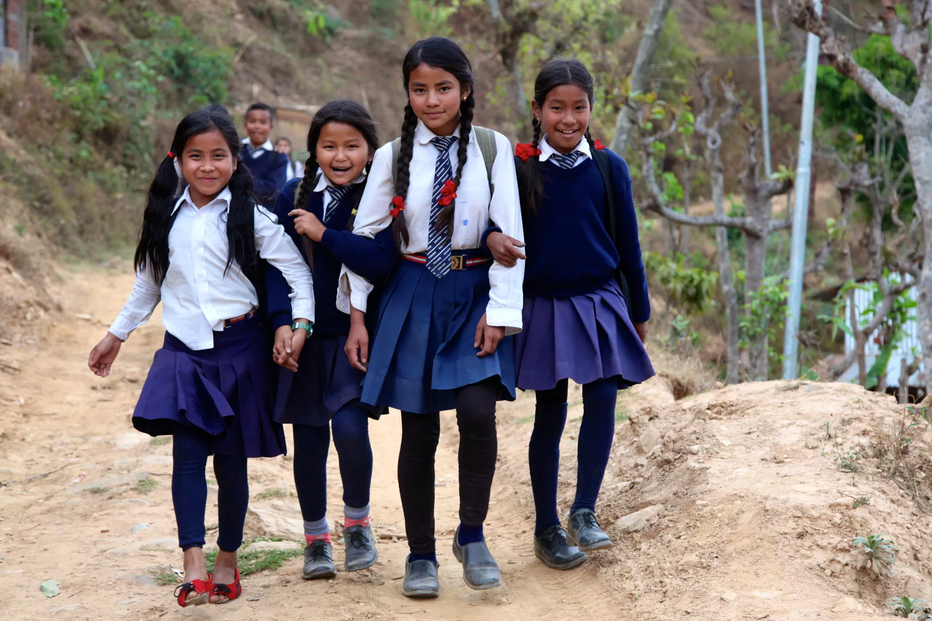 School girls in uniform going to school in Nepal village 