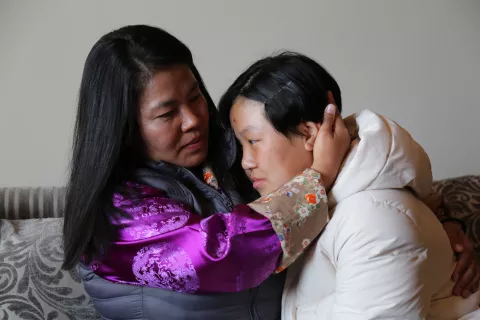 A mother consoles her teenage daughter.