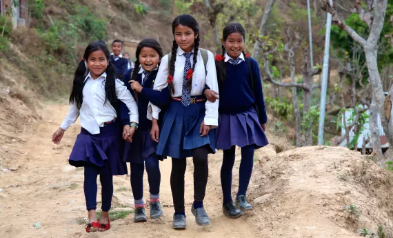 School girls in uniform going to school in Nepal village 