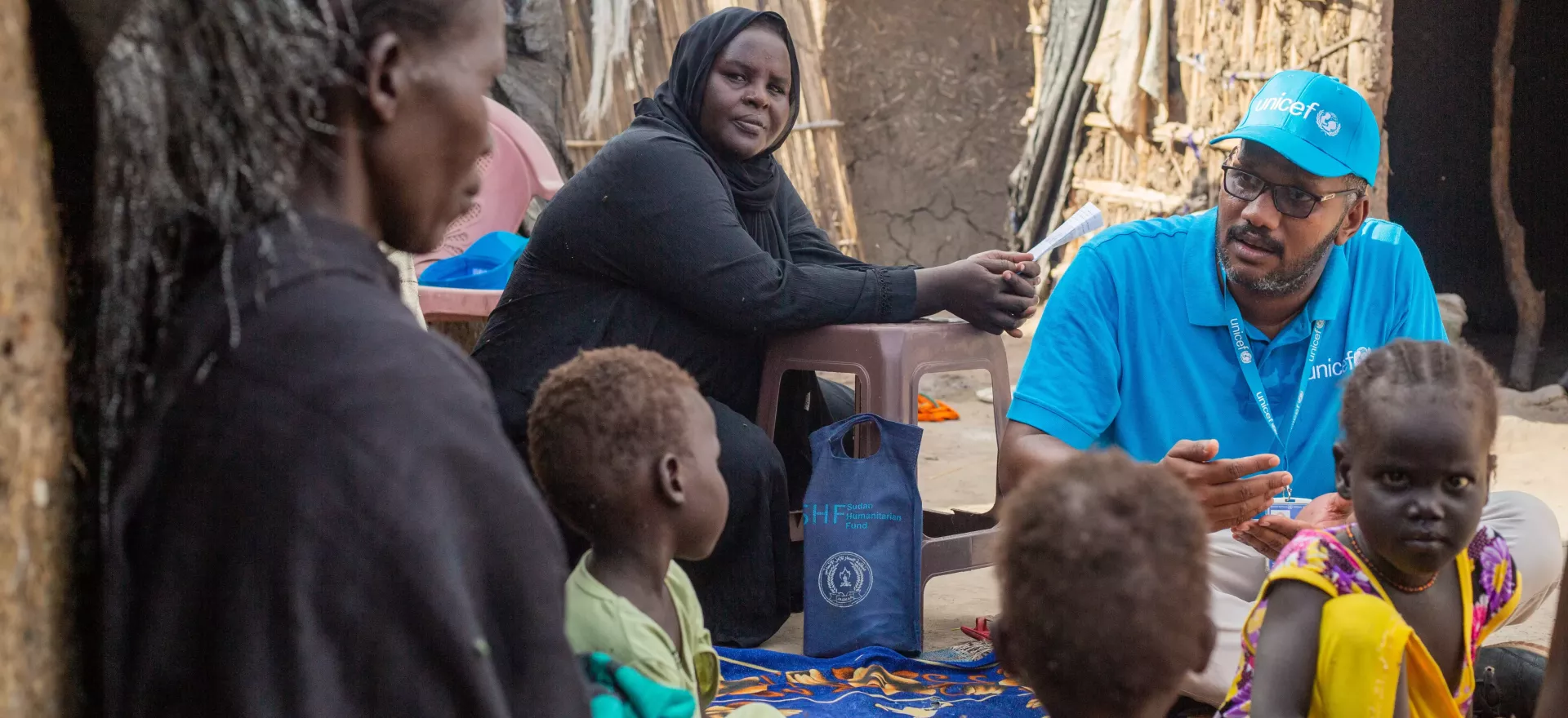 A UNICEF staff member speaks with a mother.