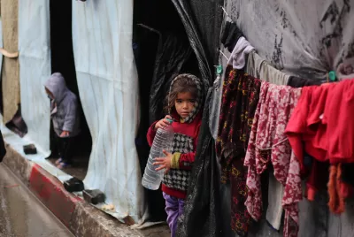 Gaza. A girl stands in front of her shelter in the city of Rafah.