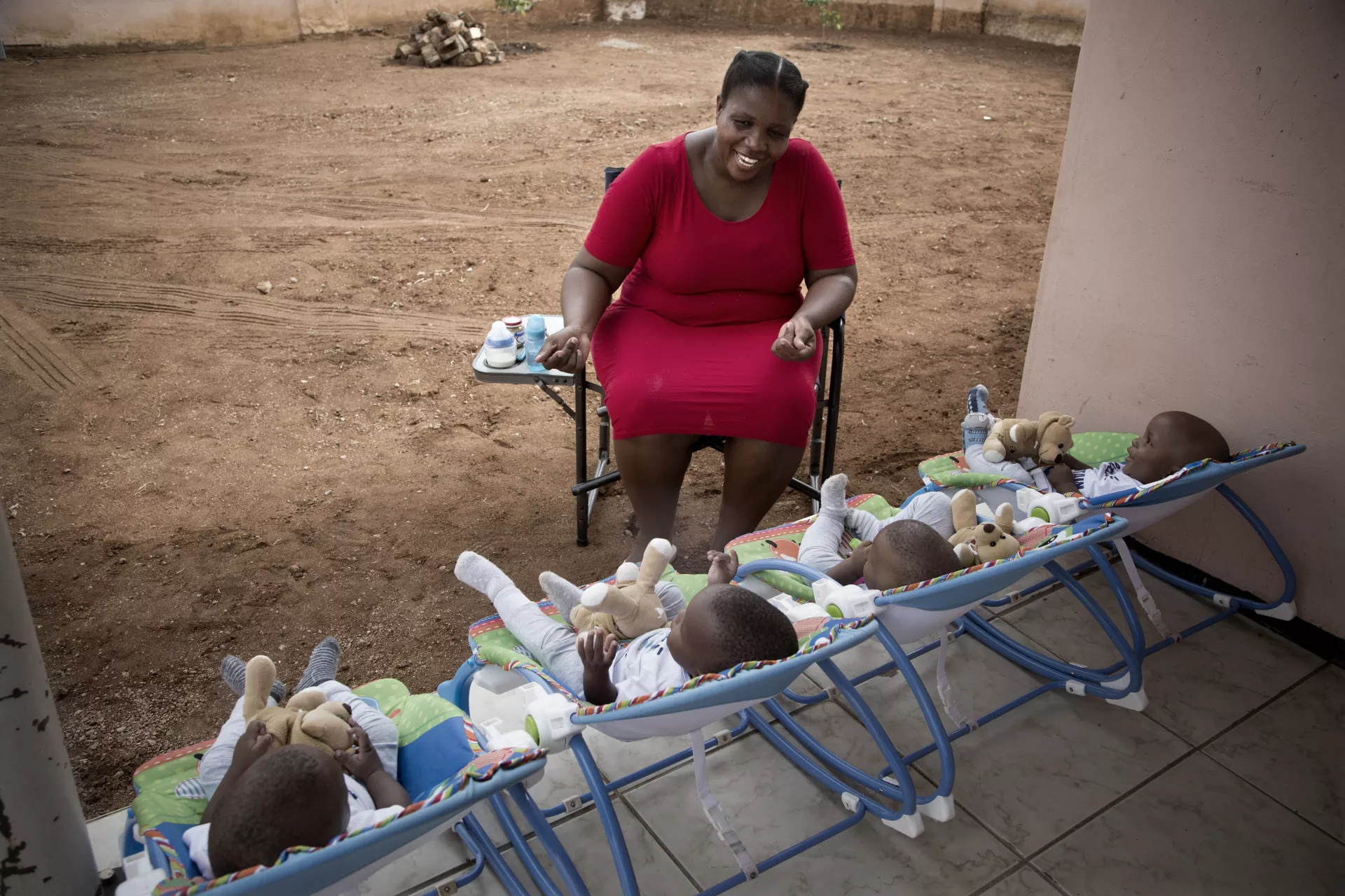 A mother feeds and plays with her quadruplets sons at home in Gaborone, Botswana.
