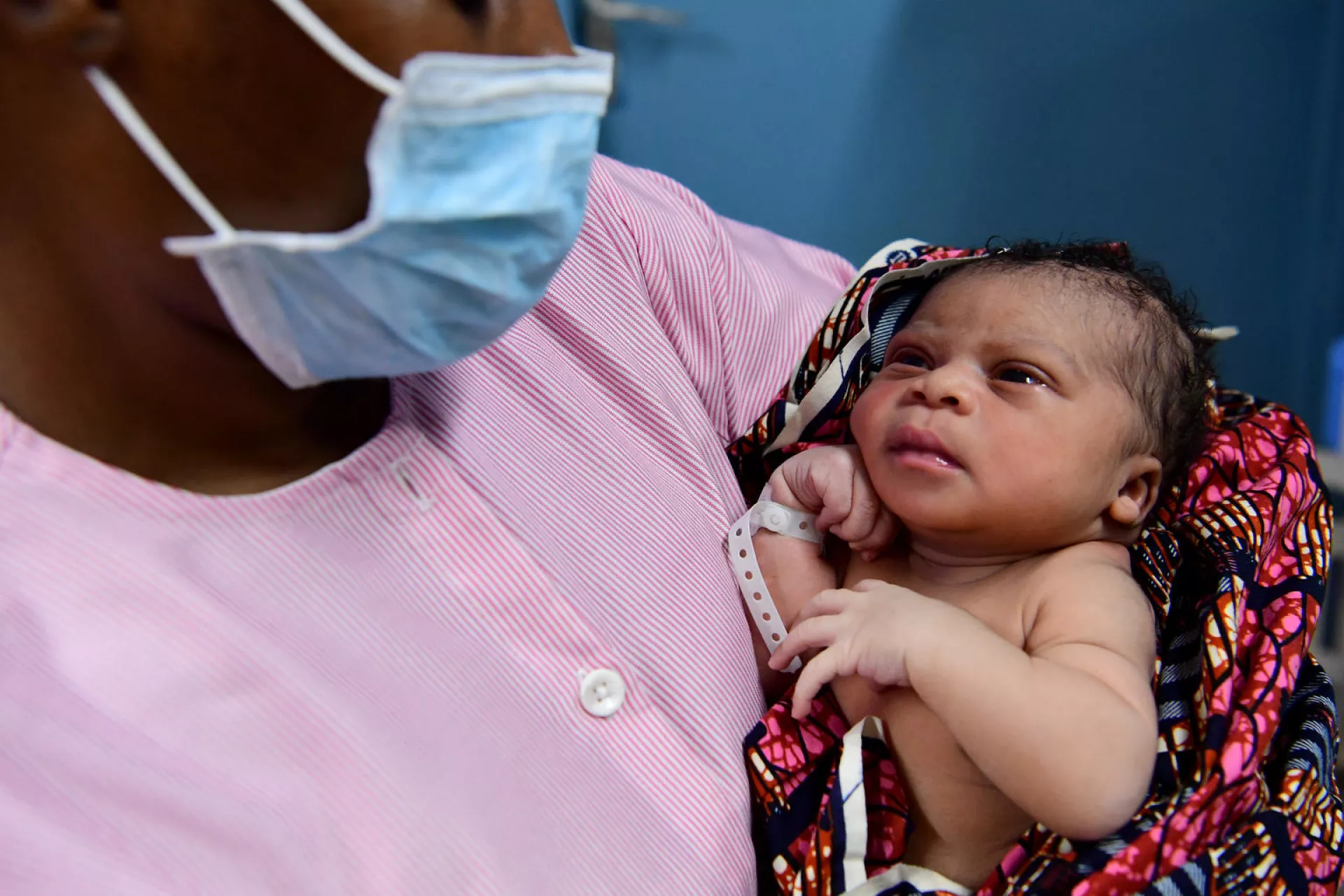 A nurse gives the first care, with a mouth mask, to a newborn in the health center of Port Bouet, a suburban f Abidjan, in the South of Côte d'Ivoire.