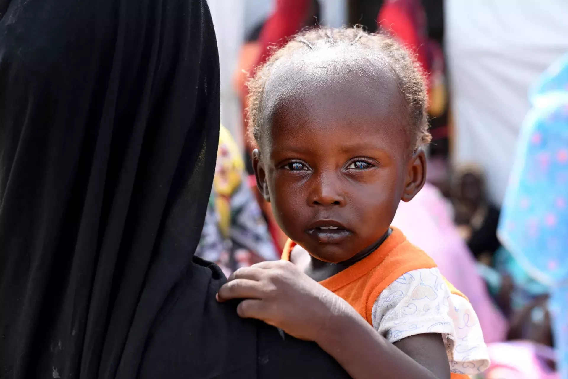 Chad. A Sudanese refugee holds her child at a site for refugees.