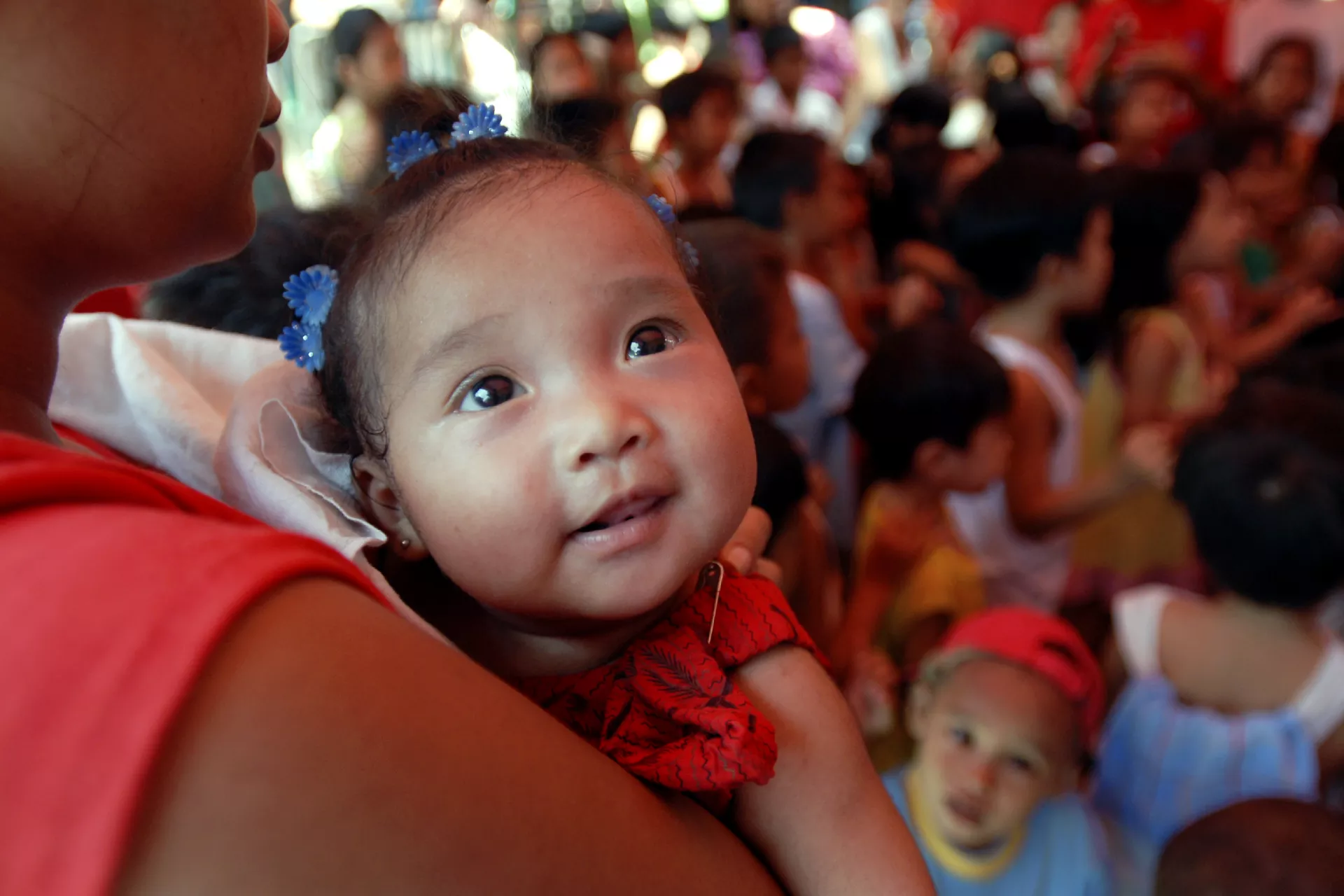 A baby is carried in the Philippines 