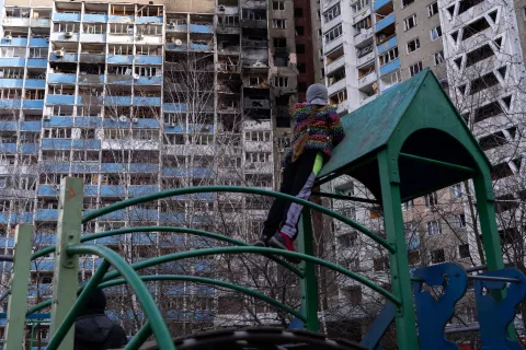 A girl is looking at the burned flats, standing on a playground at the yard of the apartment building, which suffered from shelling on the morning of February 7, 2024, Kyiv, Ukraine. 