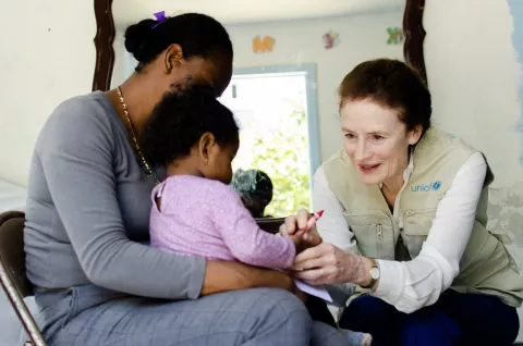 FILE PHOTO: UNICEF Executive Director Henrietta Fore speaks with a mother and her one-year old child