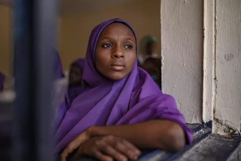 An adolescent girl sits in a classroom in Kastina College, Kastina State in Nigeria.