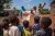 Two UNICEF workers speak about the Ebola virsu to a group of children in the Democratic Republic of Congo.