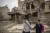 Iraq. Two children walk to school past damaged buildings in the old city area of Mosul, Iraq.