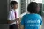 A UNICEF worker speaks with a teenage boy.
