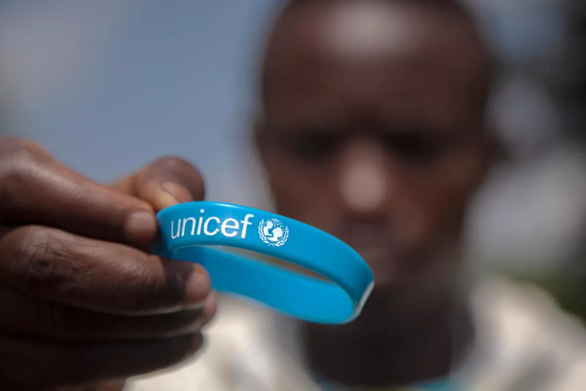 A man holds a UNICEF wristband in the Democratic Republic of Congo