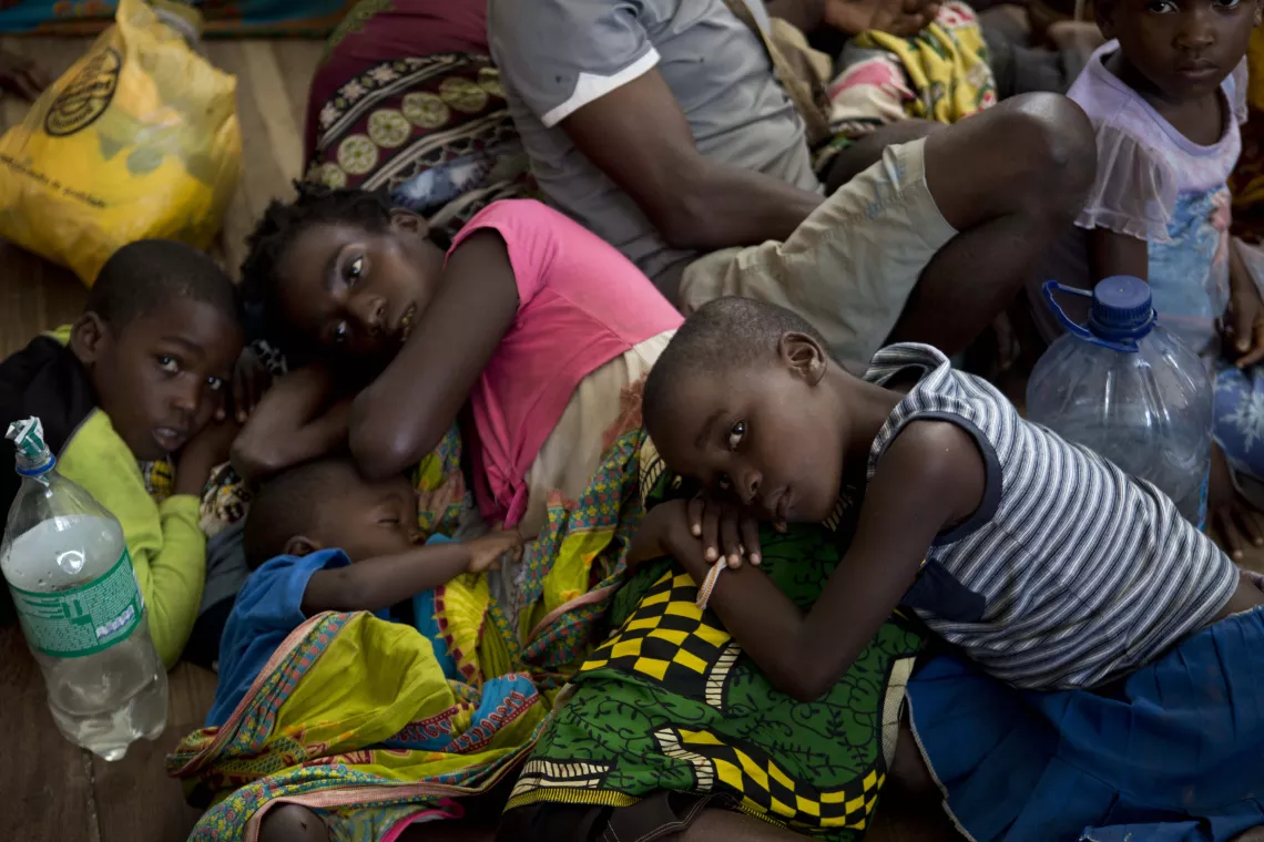 Mozambique. A group of people displaced rest at a school.