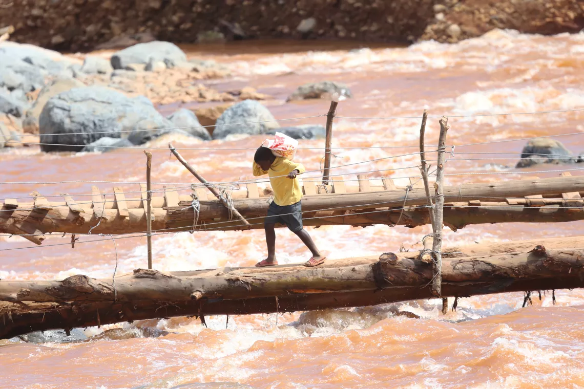 Zimbabwe. A boy walks across a bridge near where houses were swept away when Cyclone Idai hit.