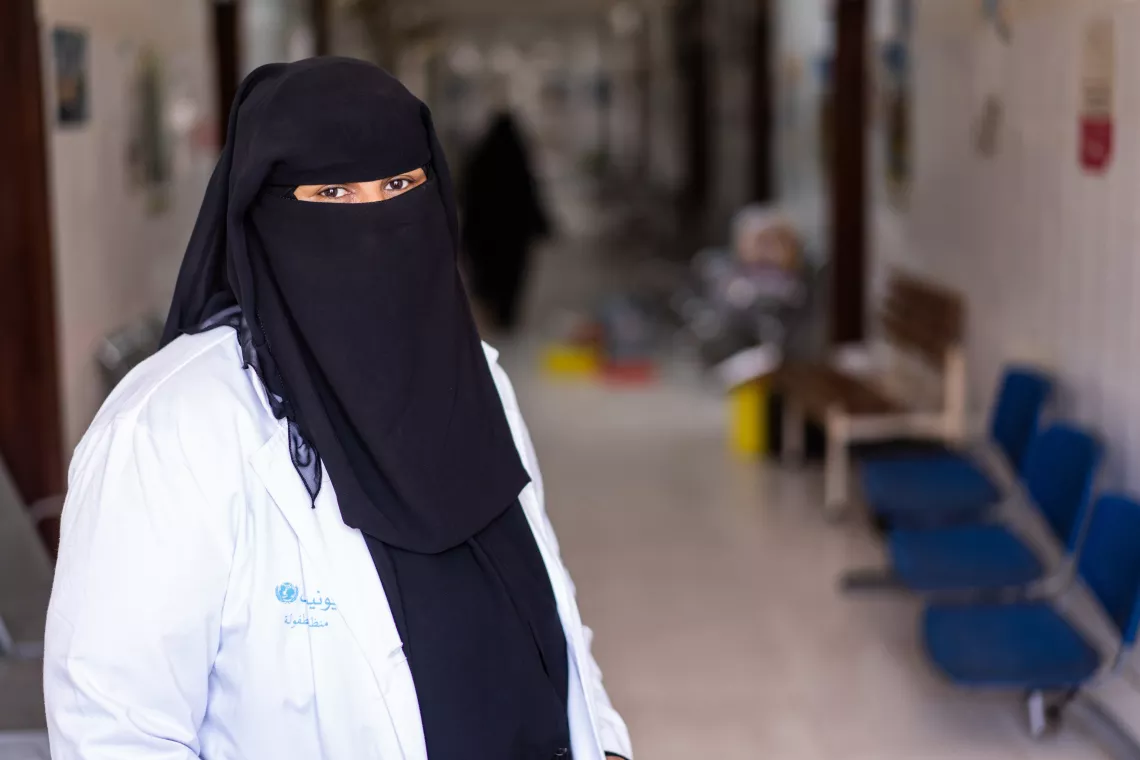 In Aden Governorate, Yemen, health worker Ghada Ali Obaid, 53, stands for a portrait in a corridor of Dar Sa’ad Medical Compound.