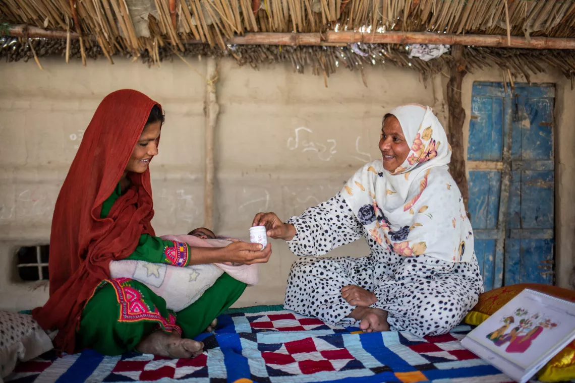 Pakistan. Roshan, right, speaks with Rozan about the benefits of Multiple Micronutrient Supplements in Thatta, Sindh Province.