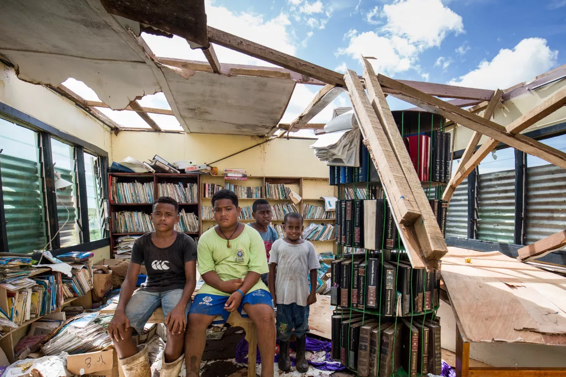 Students inside their school's library, destroyed by Tropical Cyclone Yasa in Fiji.
