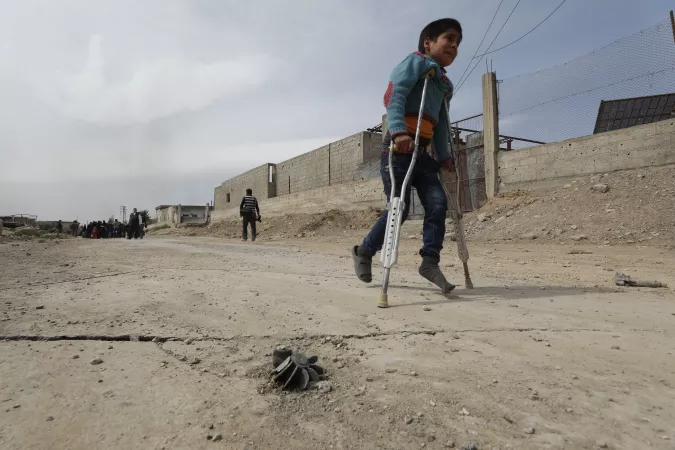 On 15 March 2018 in Beit Sawa, eastern Ghouta, boy on crutches walks towards Hamourieh where an evacuation exit from eastern Ghouta has been opened.