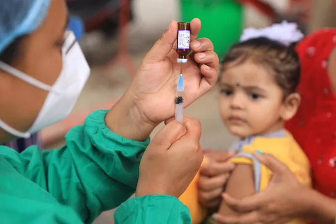 A child waits to be vaccinated in Nepal in July 2020.