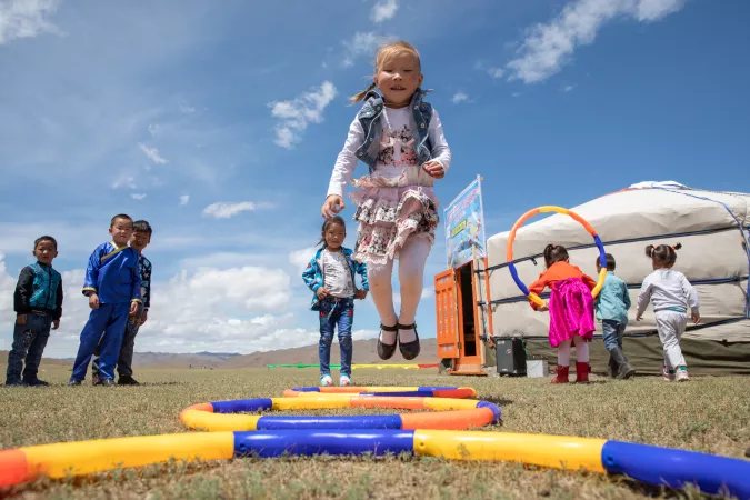Children play outdoors at the newly opened mobile ‘ger’ (traditional nomadic tent) kindergarten in the Janjin bagh area, in Erdenetsogt soum in Bayankhongor Province, Mongolia. 